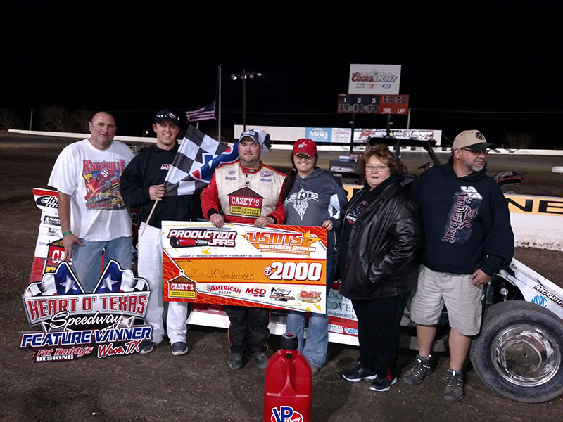 From left to right: Crew chief Danny Crane, USMTS flagman Ryne Staley, driver Zack VanderBeek, girlfriend Brittany Brown, mom Barb VanderBeek and dad Jim VanderBeek pose in victory lane after Zack won the main event on night 1 of 3 of the 7th Annual Day Motor Sports Texas Spring Nationals at the Heart O' Texas Speedway in Elm Mott, Texas.