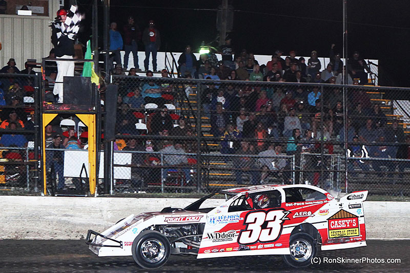 Zack VanderBeek puts his fist in the air as he takes the checkered flag first on night 3 of 3 at the 7th Annual Day Motor Sports Texas Spring Nationals at the Heart O' Texas Speedway in Elm Mott, Texas.