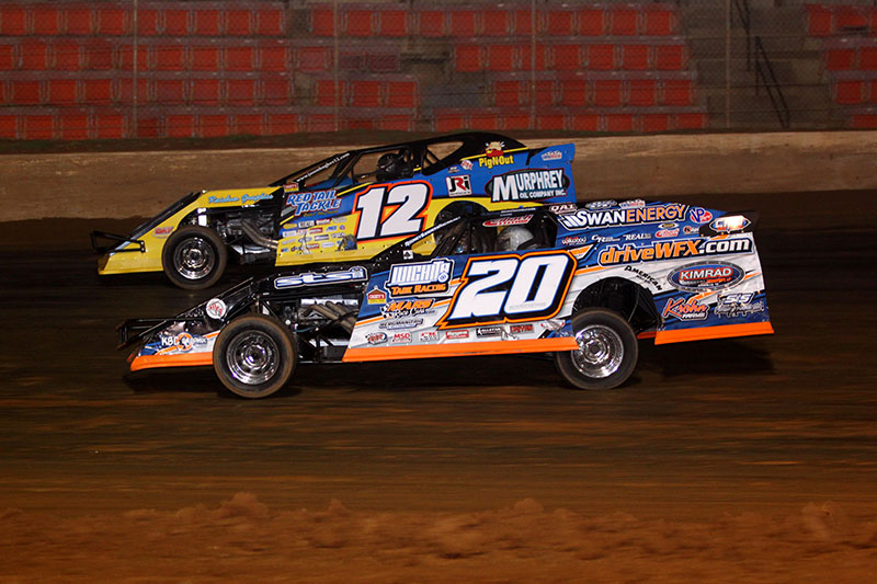 A familiar sight over the last year or more. Rodney Sanders (20) races door to door with Jason Hughes (12) on night 1 of 3 of 5th Annual Cajun Clash presented by Horseshoe Bossier City at the Ark-La-Tex Speedway in Vivian, La. (Scott Burson Photo)