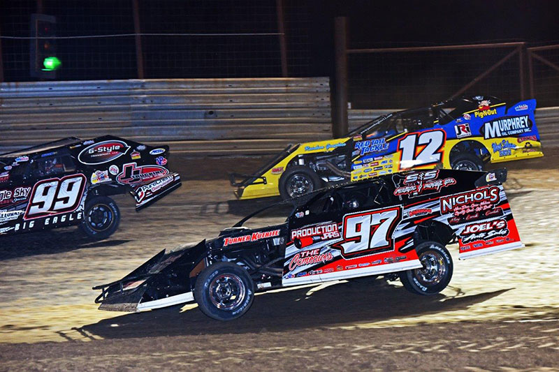 Jett Big Eagle (99) fights to stay on the lead lap while Cade Dillard (97) and Jason Hughes (12) fight for the lead during the inaugural �Cage Match� at the Atchison County Raceway in Atchison, Kan., on Sunday, April 24, 2016. (John Lee Photo)