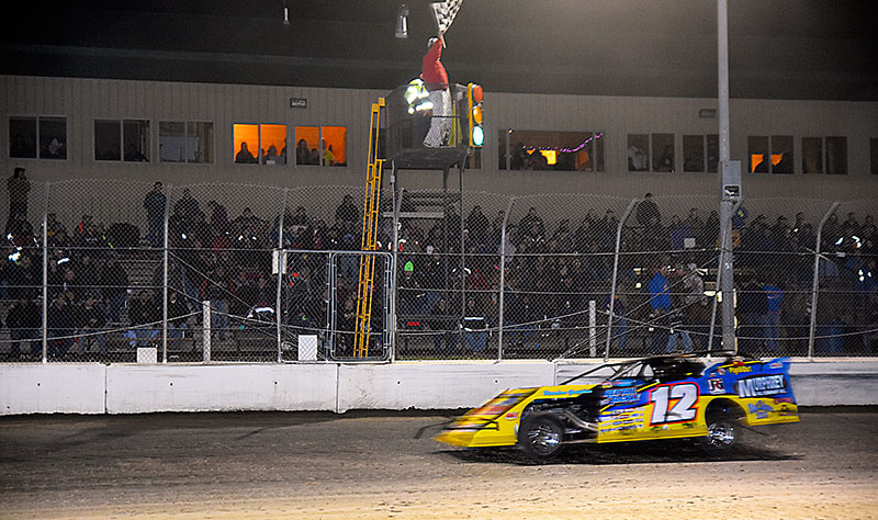 Jason Hughes takes the checkered flag for his fifth win of the season during the USMTS Casey's Cup Series event on Thursday, May 12, 2016, at the Ogilvie Raceway in Ogilvie, Minn. (Tony Radzwon Photo)