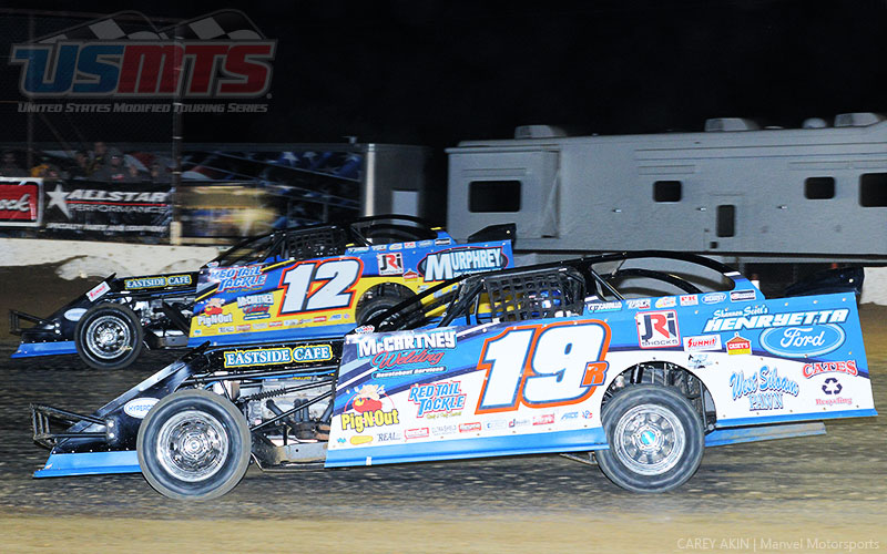 Teammates Jason Hughes (12) and Ryan Gustin (19r) battle in the main event during the Summit Racing USMTS Southern Region event at the Cotton Bowl Speedway in Paige, Texas, on Saturday, Feb. 11, 2017.