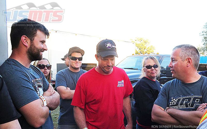 Ricky Thornton Jr. (background) smirks while tall tales and white lies are told by Cade Dillard (left), Phil Dixon (center) and Jason Hughes (right) at the drivers meeting during the Summit Racing USMTS Southern Region event at the Shady Oaks Speedway in Goliad, Texas, on Saturday, Feb. 18, 2017.