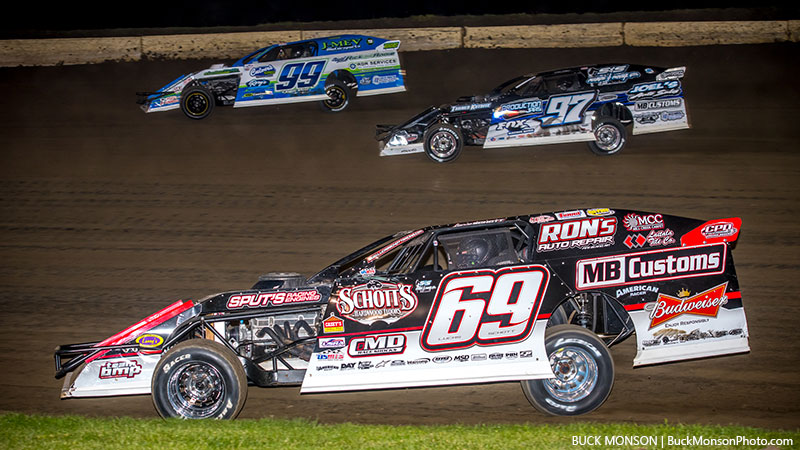 Three-way battle for the lead between Josh Angst (99), Lucas Schott (69) and eventual winner Cade Dillard (97) during the main event at the 15th Annual USMTS Southern MN Spring Challenge at the Deer Creek Speedway in Spring Valley, Minn., on Saturday, May 27, 2017.