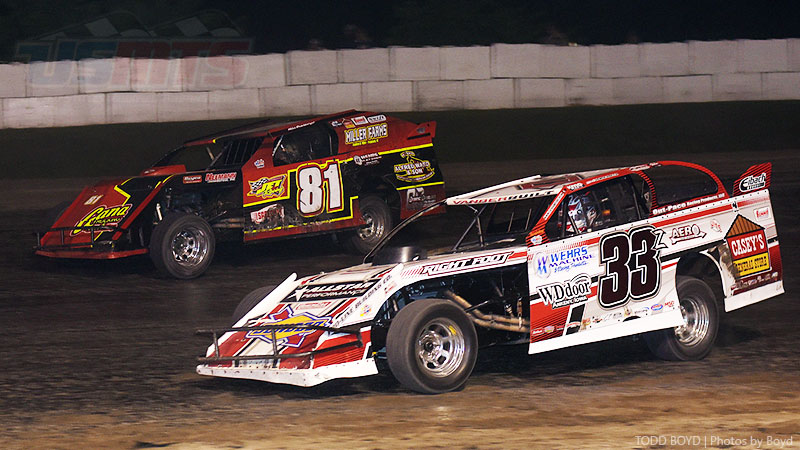 Zack VanderBeek (33z) and Mike Densberger (81) battle for position during the main event at the 3rd Annual USMTS Southern Kansas Nationals at the Caney Valley Speedway in Caney, Kan., on Tuesday, June 6, 2017.