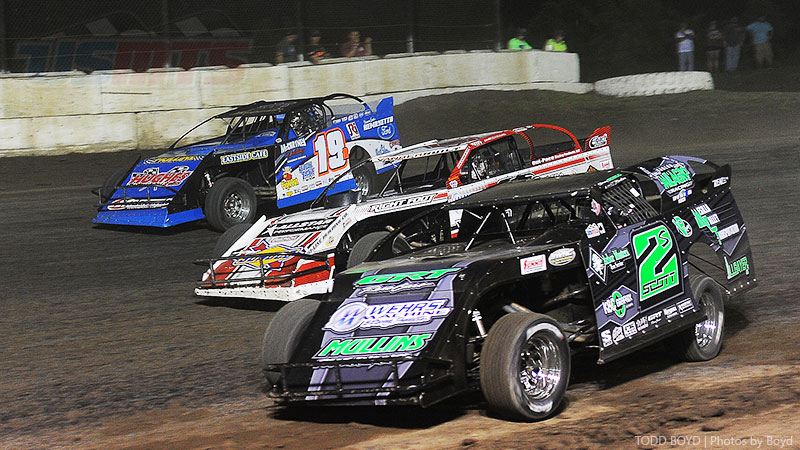 Three-wide action between Ryan Gustin (19R), Zack VanderBeek (33z) and Stormy Scott (2s) during the 3rd Annual USMTS Southern Kansas Nationals at the Caney Valley Speedway in Caney, Kan., on Tuesday, June 6, 2017.