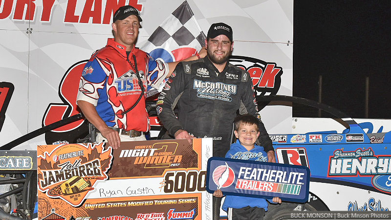 Ryan Gustin is joined by his son and flagman Ryne Staley after winning the USMTS feature during the 19th Annual Featherlite Fall Jamboree at the Deer Creek Speedway in Spring Valley, Minn., on Friday, Sept. 22, 2017.