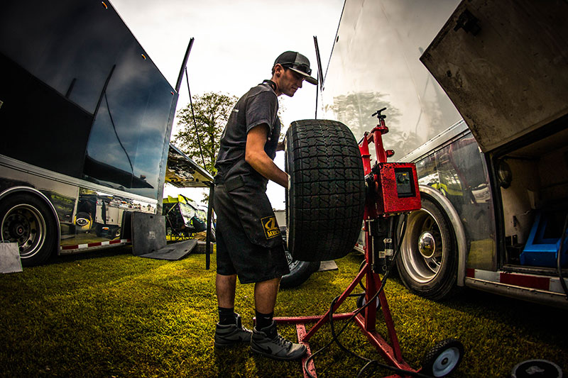 A crewmember prepares tires during practice on Wednesday, April 10, at the Ark-La-Tex Speedway in Vivian, La., in preparation for the 7th Annual USMTS Cajun Clash on Thursday, Friday and Saturday, April 11-13.