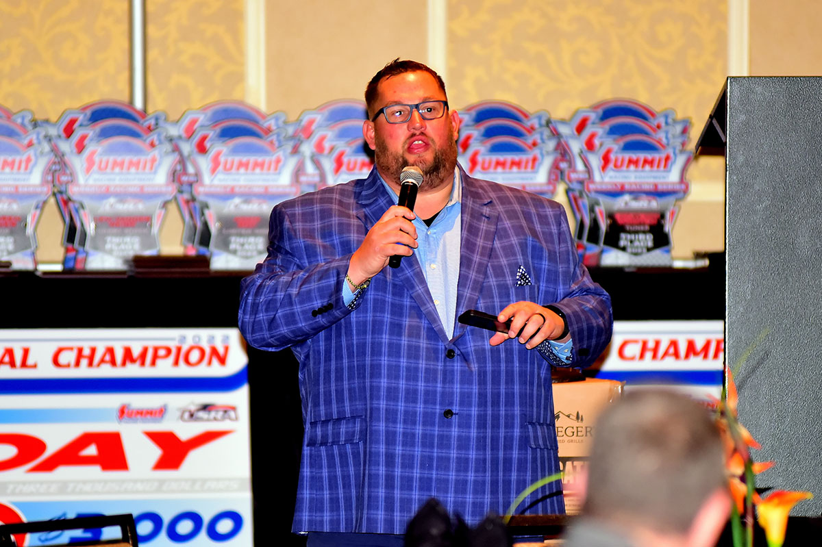 Emcee of the evening, Bryan Denekas. Denekas is a long-time announcer at the Sports Park Raceway in Fort Dodge, Iowa, and Hamilton County Speedway in Webster City, Iowa, as well as the Summit USRA Nationals. He recently stepped down as the general manager of the Sports Park Raceway.