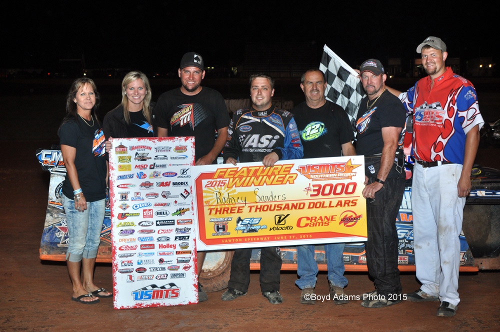 Rodney Sanders celebrates with crew members and family after winning the USMTS main event on Saturday, June 27, 2015, at the Lawton Speedway in Lawton, Okla.