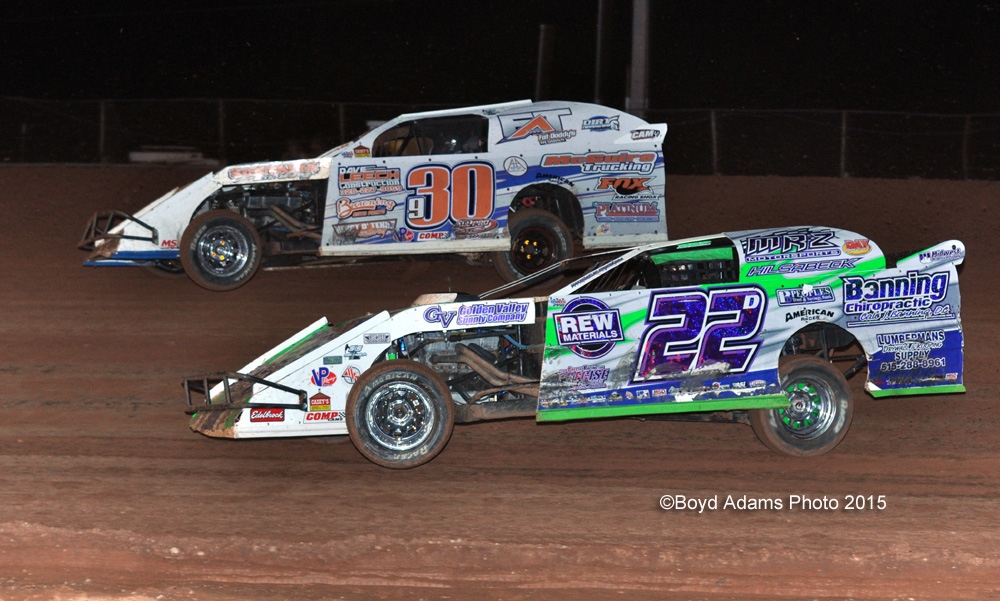 Daniel Hilsabeck (22d) drives past Chase Allen (30)) in Real Racing Wheels "B" Main #2 during the USMTS event on Saturday, June 27, 2015, at the Lawton Speedway in Lawton, Okla.