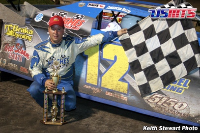 Jason Hughes poses next to his #12 Hughes Modified after winning the Iowa State Fair Speedway event. 