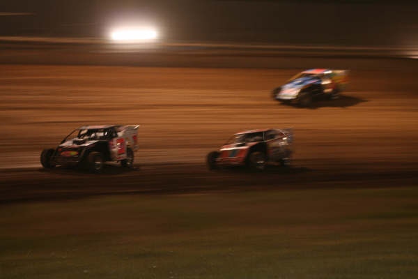 The top three race close during the main event. Greg Skaggs leads Kelly Shryock around the bottom while Jason Hughes uses the high side on the Bolivar clay. (Photo credit: Chris Bork) 