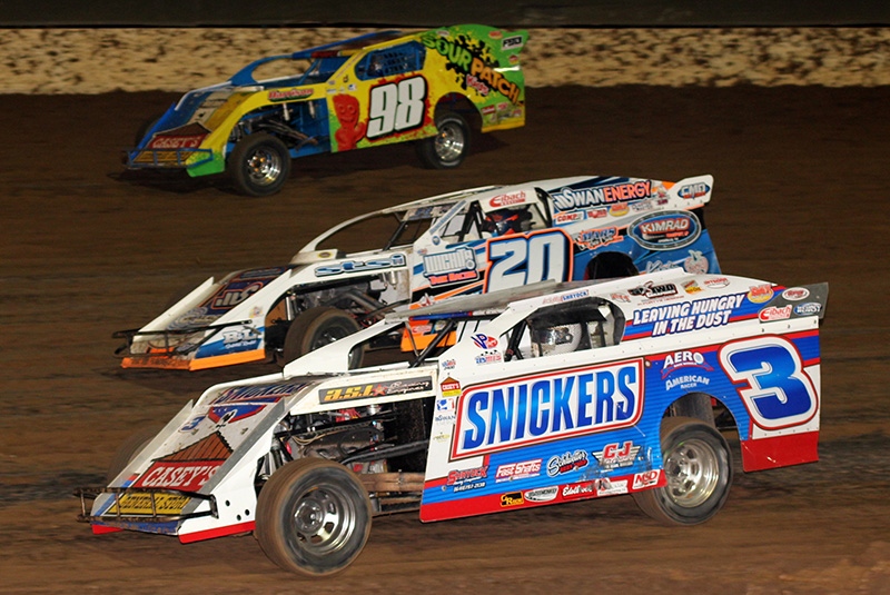 Kelly Shryock (3), Rodney Sanders (20) and John Allen (98) battle in the main event during the 5th Annual Lucas Slick Mist Show-Me Shootout at the Lucas Oil Speedway in Wheatland, Mo., on Saturday, Aug. 9. (Chris Bork Photo)