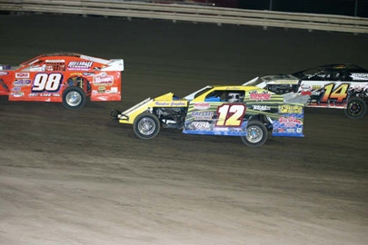 The top three battle in the main event: John Allen (98), Jason Hughes (12) and Jon Tesch (14). Allen went on to win, Tesch was second and Hughes dropped out with a blown engine. (Justin Sly Photo) 
