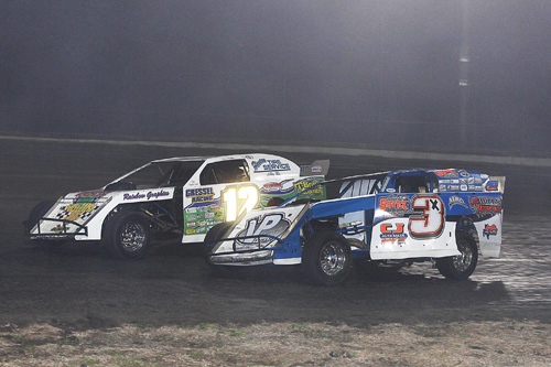 Defending USMTS National Champion Jason Hughes of Watts, Okla., races with leader Chris Brown of Spring, Texas (driving Kelly Shryock's backup car), in turn 1. On the next lap, the two got together on the front-stretch, resulting in both spinning out and being sent to the rear of the field. (RonSkinnerPhotos.com Photo)