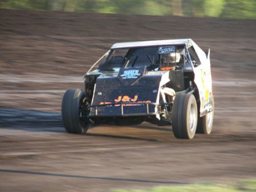 Jason Hughes was third in the fifth heat race as he lifts the left front coming off of turn 2. 