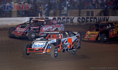 With two laps to go, the race for the win was just this close between Jason Cummins (71), Al Hejna (7) and Corey Dripps (31). 