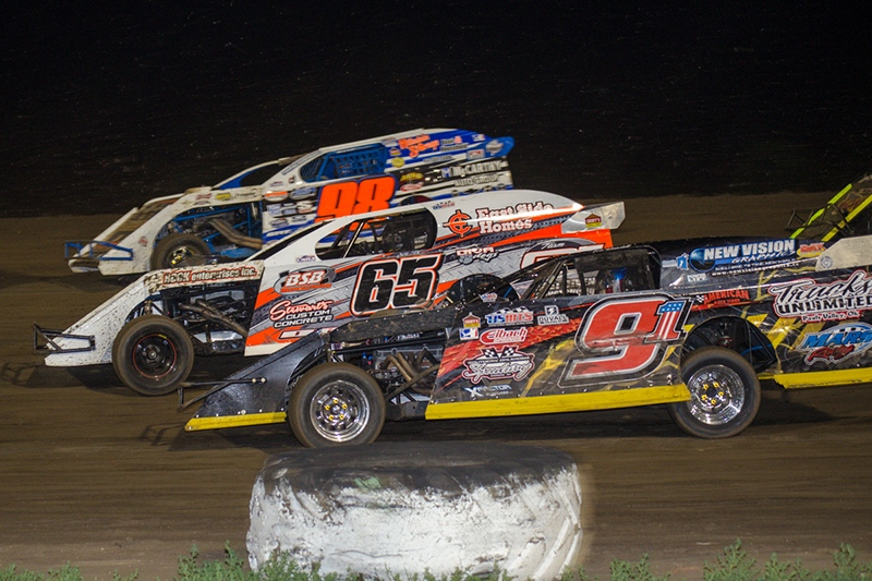 John Allen (98), Tyler Davis (65) and Joe Duvall (91) battle early on in the main event on Thursday, June 19, at the 81 Speedway in Park City, Kan. (Dusty Wiegert Photo)