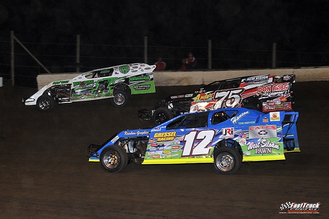 Jason Hughes (12), Terry Phillips (75) and Johnny Scott (1st) battle for the lead at the 15th Annual Featherlite Fall Jamboree. (Lloyd Collins Photo) 