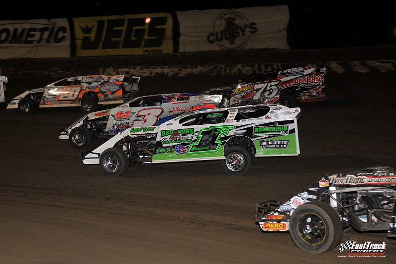 Feature race action at the I-80 Speedway during the Silver Dollar Nationals. Rodney Sanders (20), Kelly Shryock (3), Terry Phillips (75) and Johnny Scott (1st).