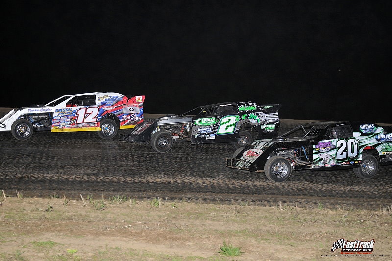 Jason Hughes (12) leads Stormy Scott (2s) and Bryan Rowland (20r) early in the feature. (Lloyd Collins Photo)