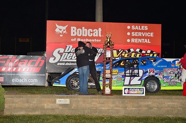 Jason Hughes gets a hug from crew chief Steve Karver after winning the 15th Annual Featherlite Fall Jamboree at the Deer Creek Speedway. (Buck Monson Photo)