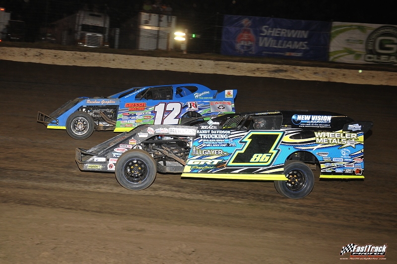 Jeremy Payne (186) and Jason Hughes (12) battle for second in the feature race during the 3rd Annual Silver Dollar Nationals at the I-80 Speedway in Greenwood, Neb.
